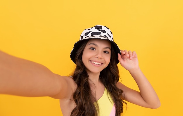 Photo cheerful child with curly hair make selfie fashion accessory express positive emotions