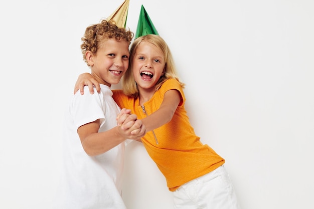 Cheerful children in multicolored caps birthday holiday emotion isolated background unaltered