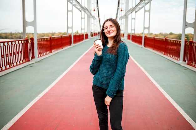 Cheerful coffee lover walking on street