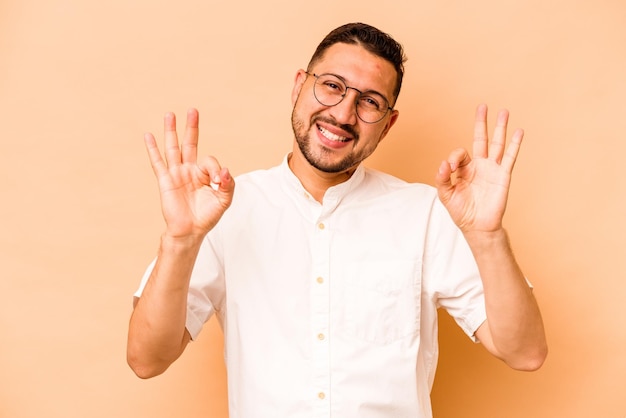 Cheerful and confident showing ok gesture