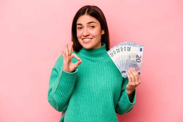 Cheerful and confident showing ok gesture