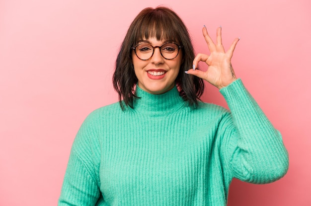 Cheerful and confident showing ok gesture