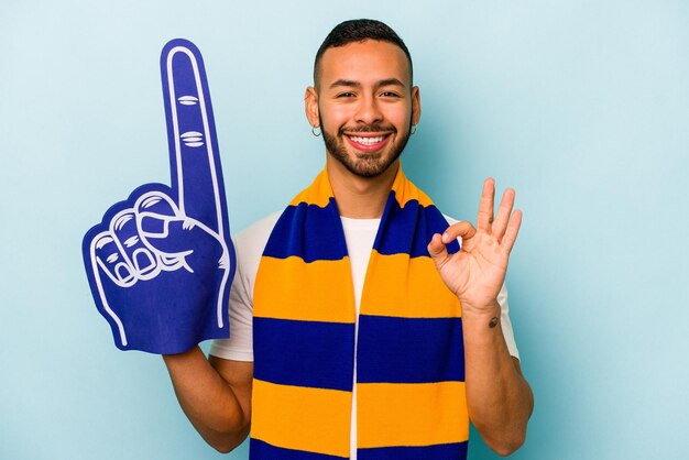 Cheerful and confident showing ok gesture