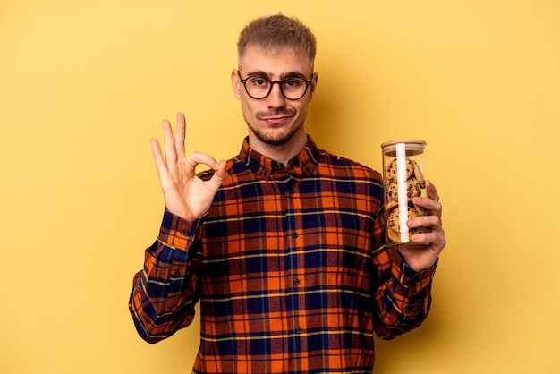 Cheerful and confident showing ok gesture