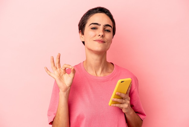 Cheerful and confident showing ok gesture