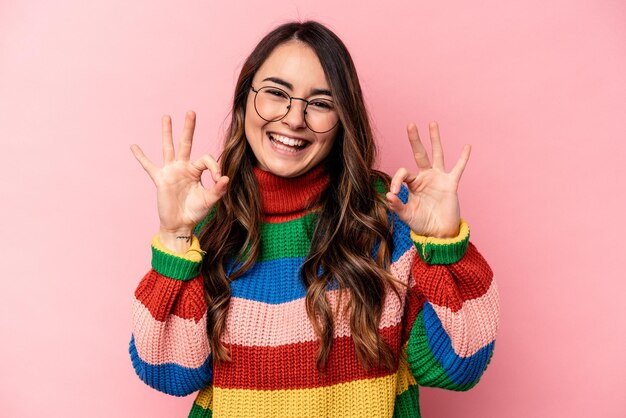 Cheerful and confident showing ok gesture