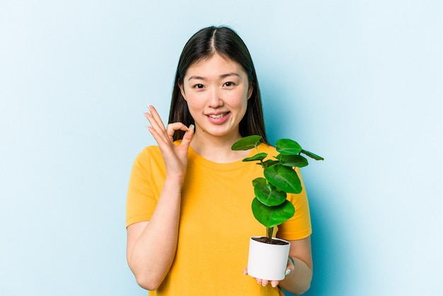 Cheerful and confident showing ok gesture