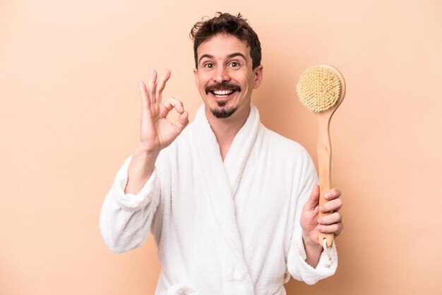 Cheerful and confident showing ok gesture