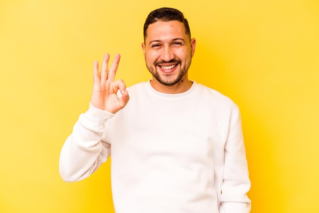 Cheerful and confident showing ok gesture