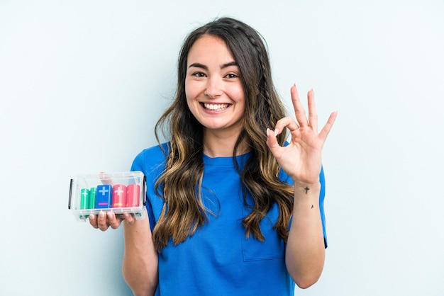 Cheerful and confident showing ok gesture