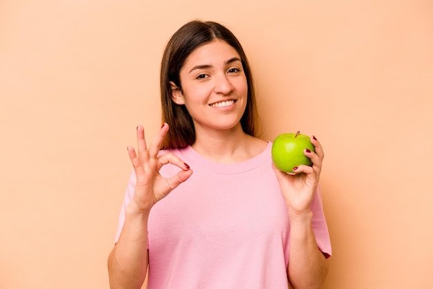 Cheerful and confident showing ok gesture