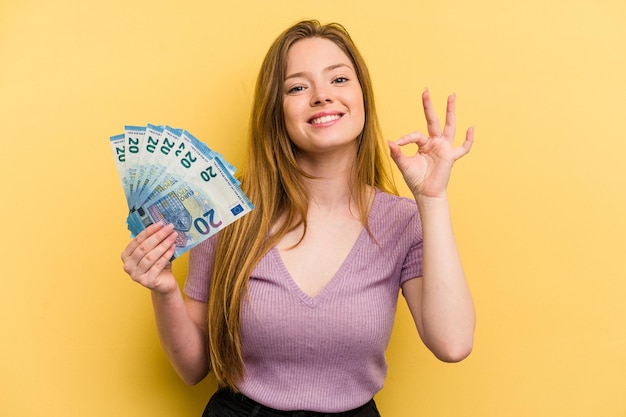 Cheerful and confident showing ok gesture