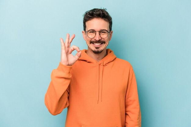 Cheerful and confident showing ok gesture