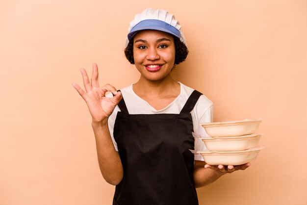 Cheerful and confident showing ok gesture