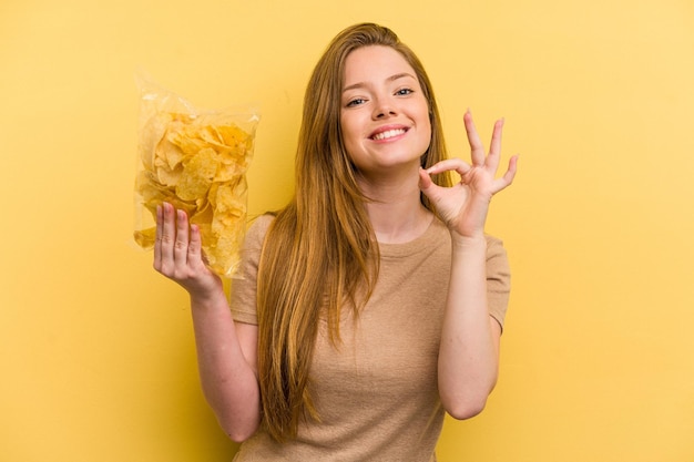 Cheerful and confident showing ok gesture