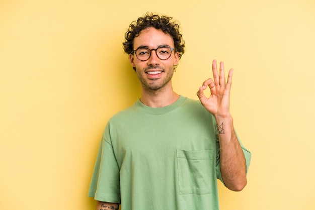 Cheerful and confident showing ok gesture