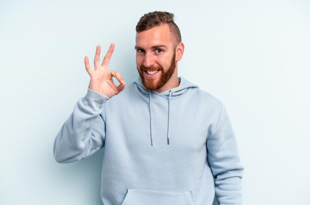 Cheerful and confident showing ok gesture