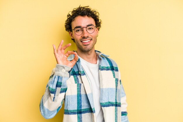 Cheerful and confident showing ok gesture