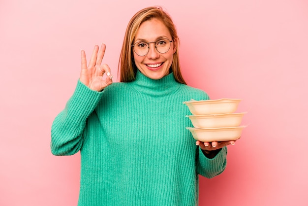 Cheerful and confident showing ok gesture