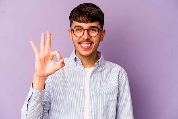 Cheerful and confident showing ok gesture