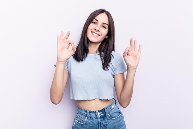 Cheerful and confident showing ok gesture