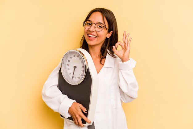 Cheerful and confident showing ok gesture