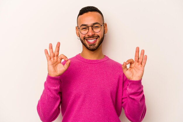 Cheerful and confident showing ok gesture