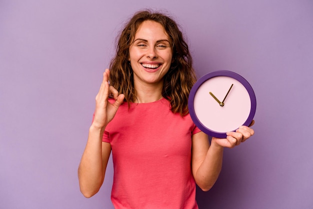 Cheerful and confident showing ok gesture