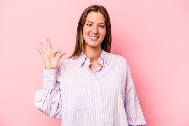 Cheerful and confident showing ok gesture