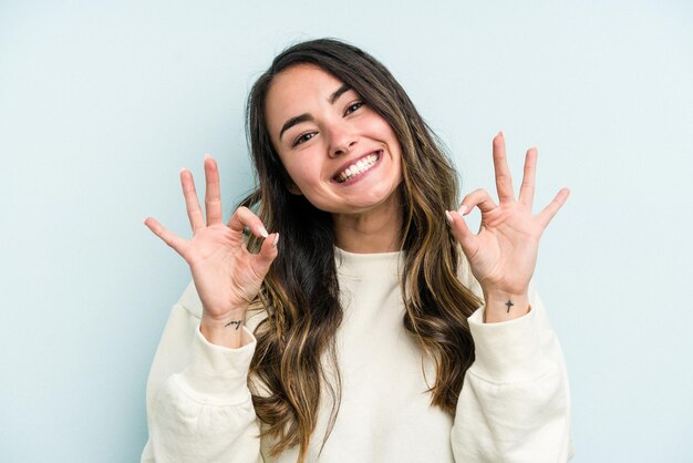 Cheerful and confident showing ok gesture