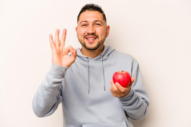 Cheerful and confident showing ok gesture