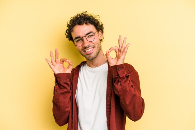 Cheerful and confident showing ok gesture