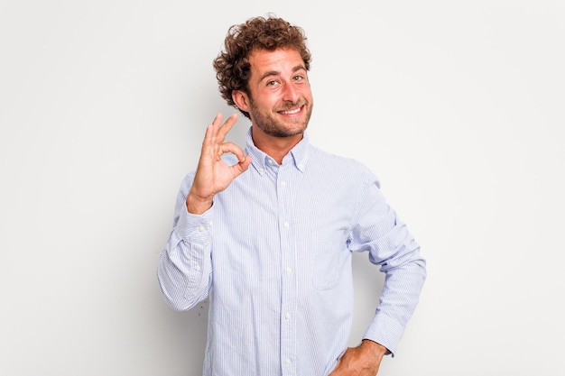 Cheerful and confident showing ok gesture