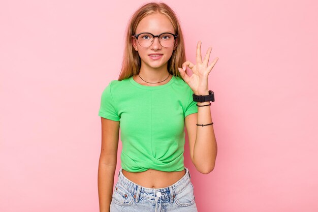 Cheerful and confident showing ok gesture