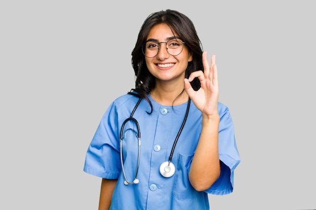 Cheerful and confident showing ok gesture