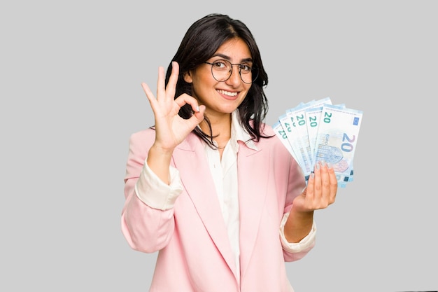 Cheerful and confident showing ok gesture