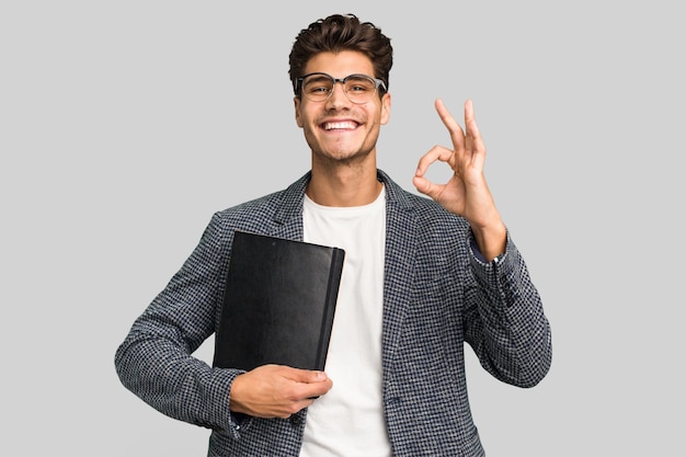 Cheerful and confident showing ok gesture