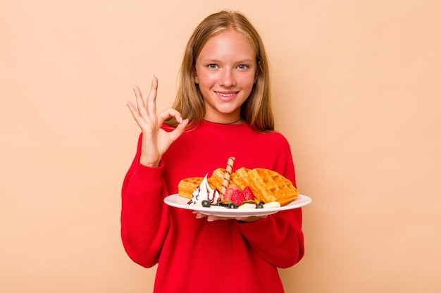 Cheerful and confident showing ok gesture