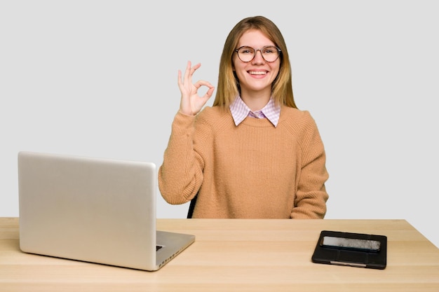 Cheerful and confident showing ok gesture