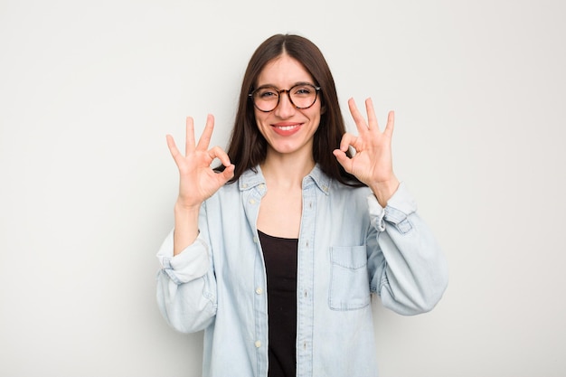 Cheerful and confident showing ok gesture