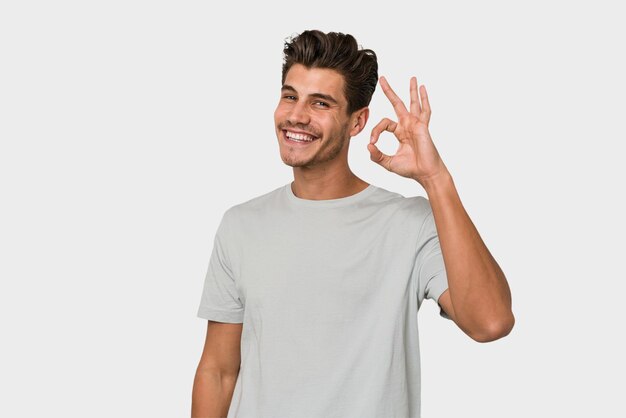 Cheerful and confident showing ok gesture