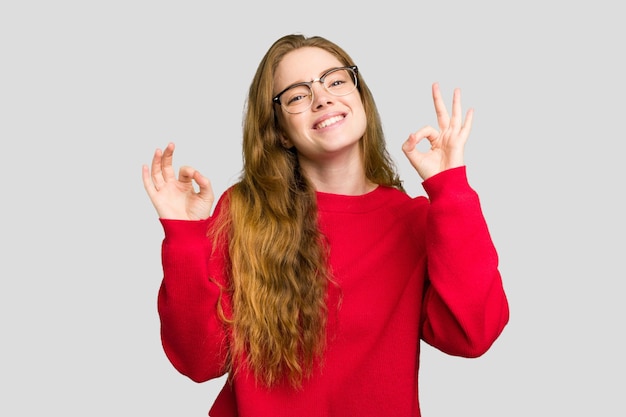 Cheerful and confident showing ok gesture