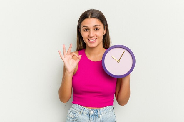 Cheerful and confident showing ok gesture