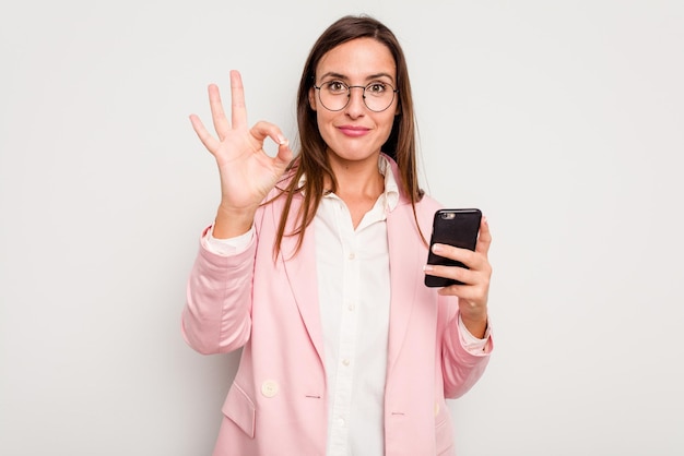 Cheerful and confident showing ok gesture