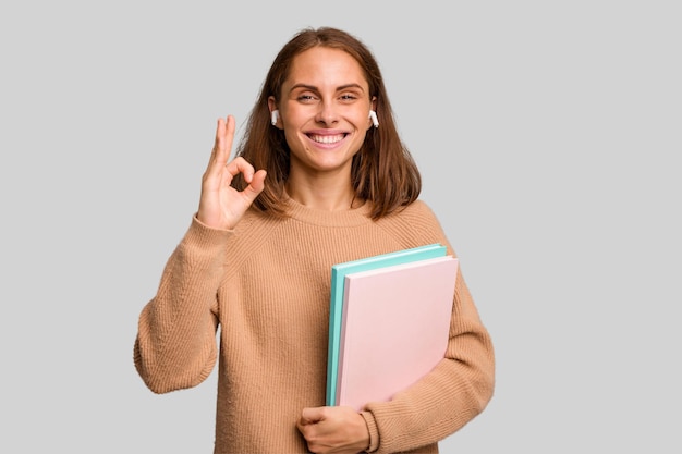 Cheerful and confident showing ok gesture