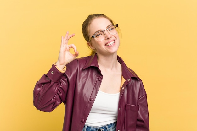 Cheerful and confident showing ok gesture