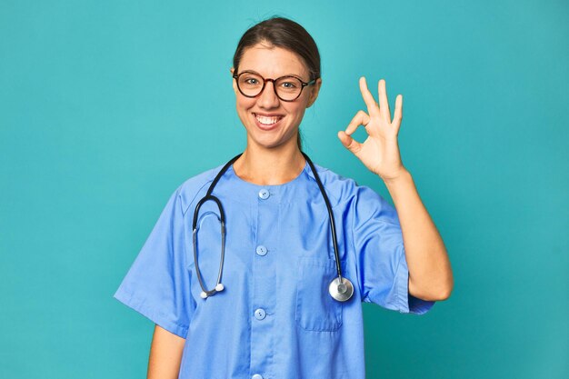 Cheerful and confident showing ok gesture