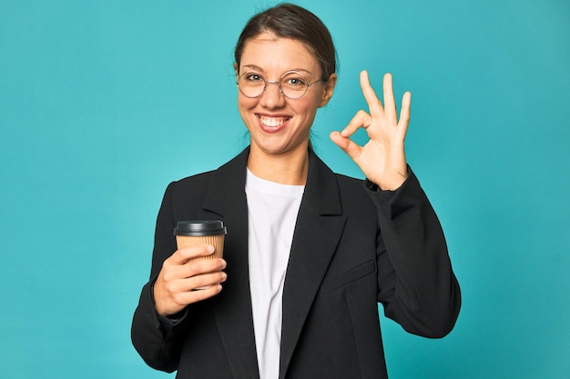 Cheerful and confident showing ok gesture