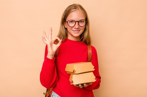 Cheerful and confident showing ok gesture