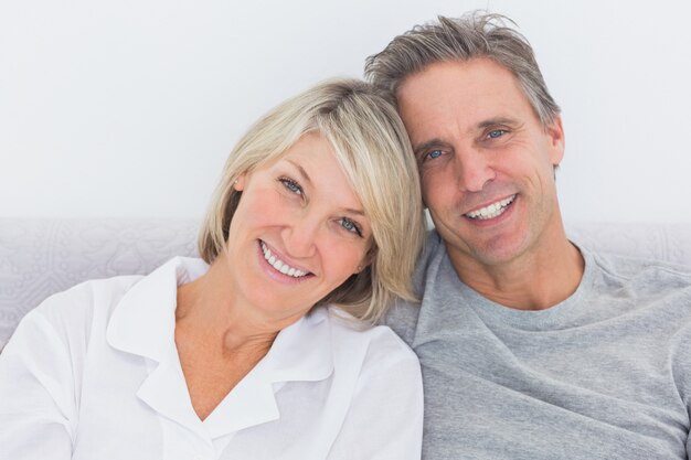 Cheerful couple in bed